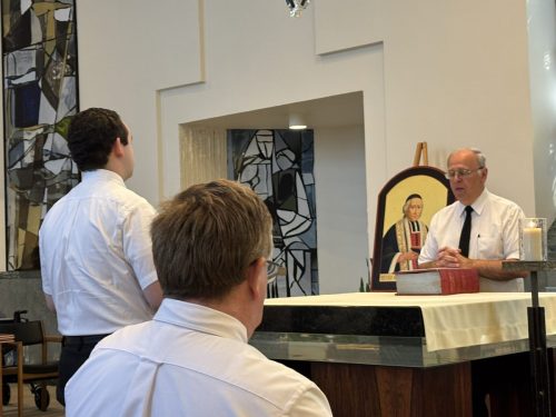 Bro. Joseph, provincial superior, reads the exhortation as Bro. Michael Patrick prepares to renew his temporary vows.