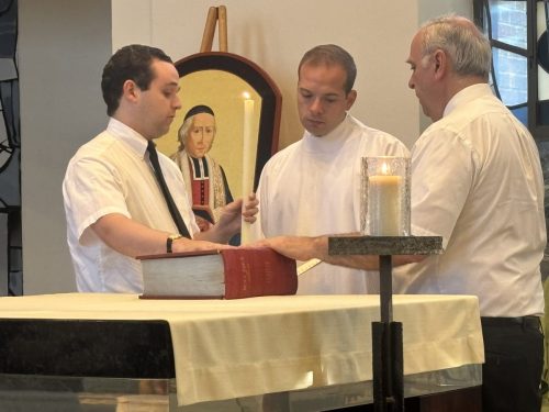 Bro. Michael Patrick renews his temporary vows, received by the provincial and assisted by Bro. Patrick.
