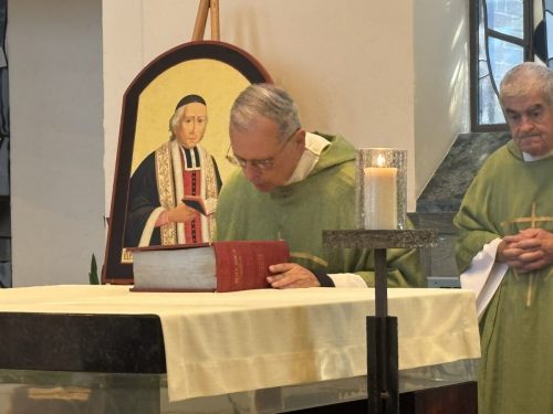 Fr. Thomas kisses the Bible as he re-affirms his perpetual vows.